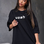 black oversized tee with the brand name 'voah' printed on the front and a paint splatter graphic design on the back.